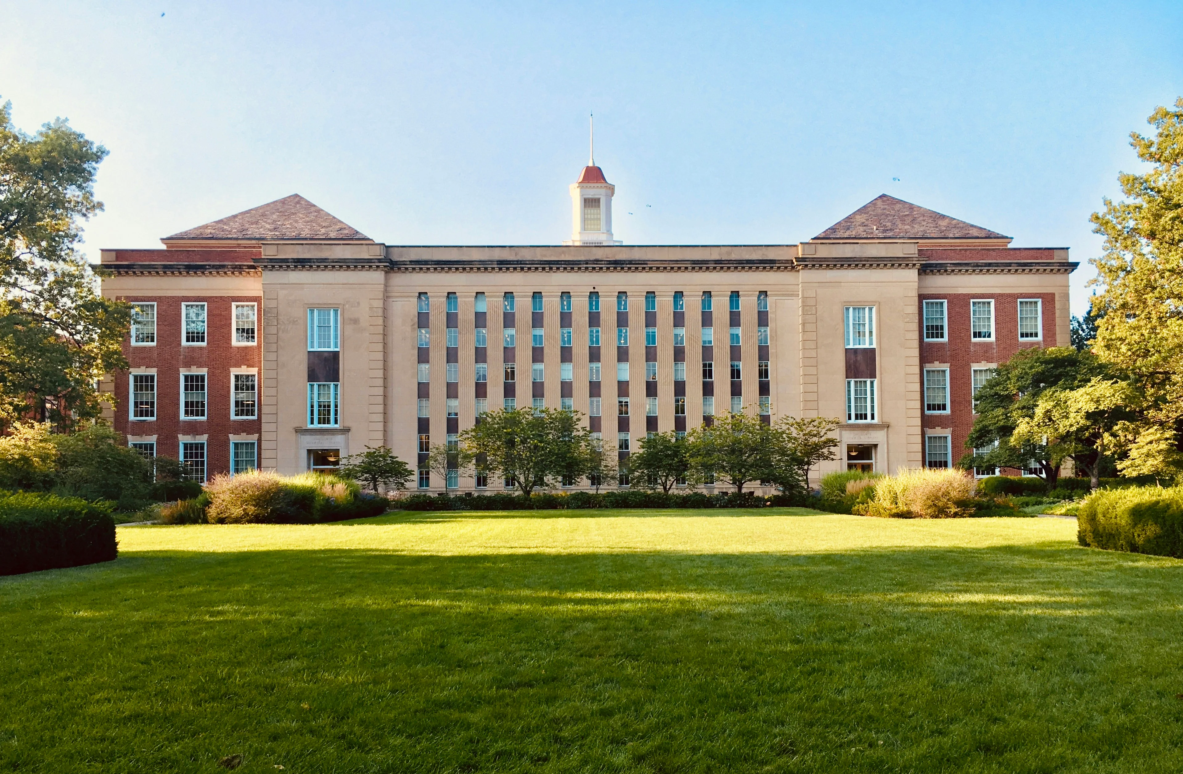 A university campus with established architecture and open lawn.