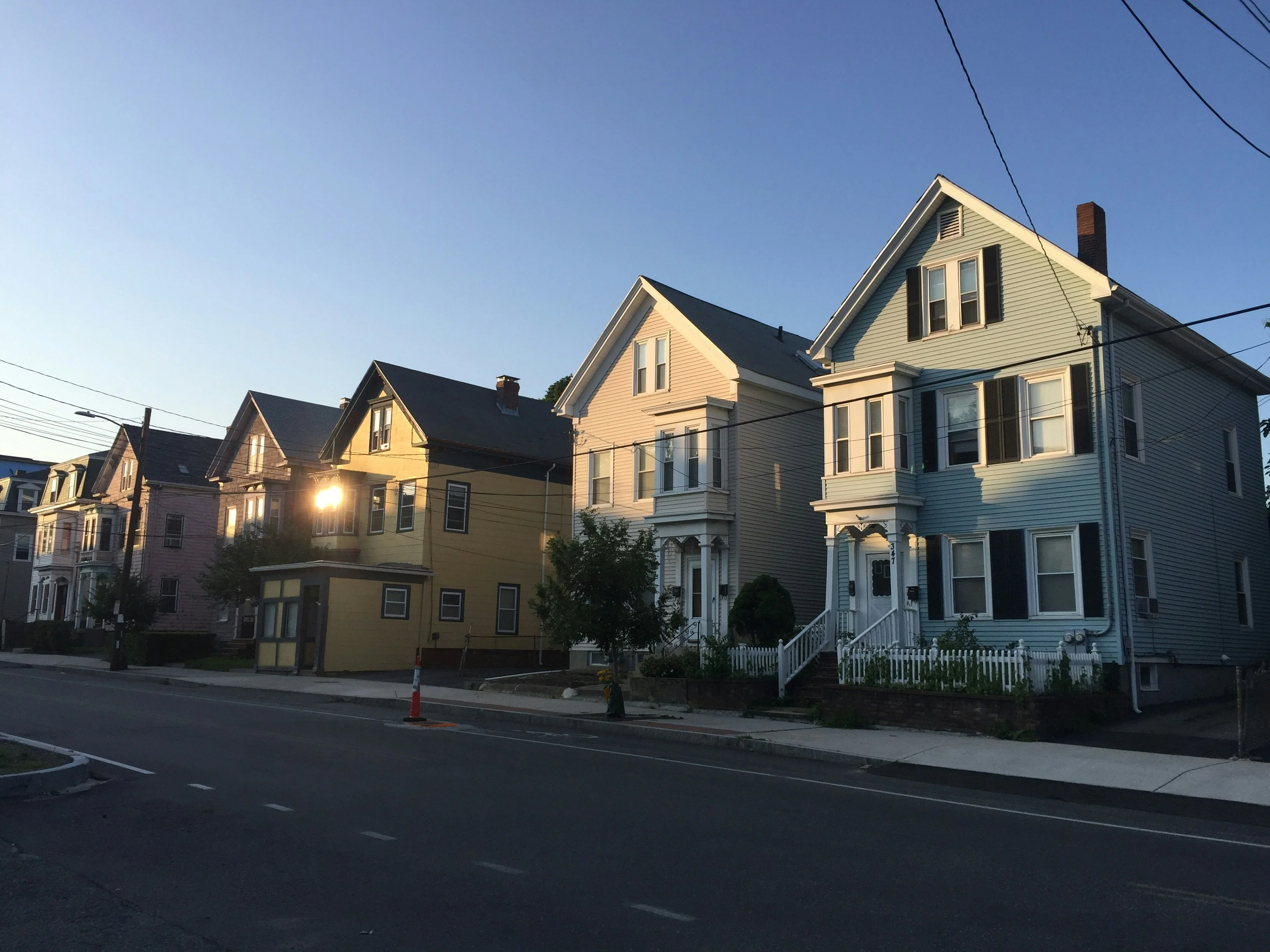 Neighborhood houses with green yards.